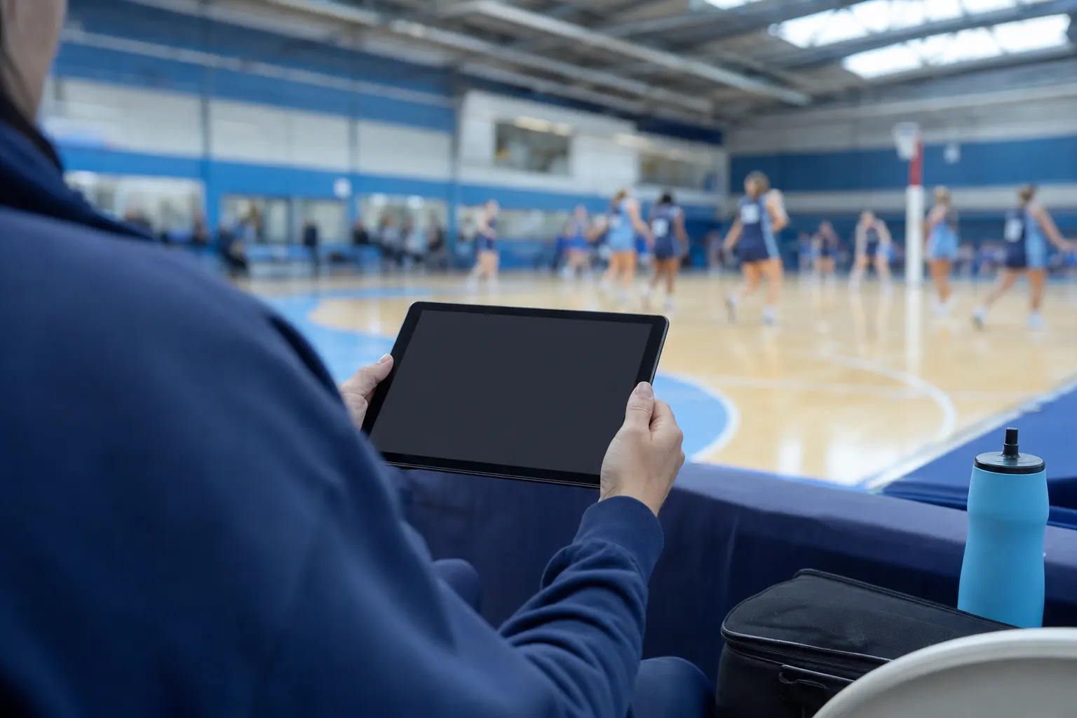 A selector holding a tablet courtside